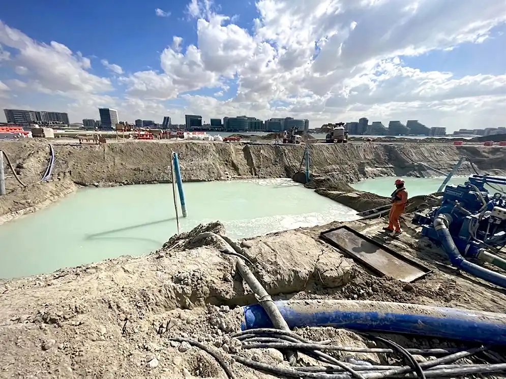 Coastal Dewatering Excavation Dewatering operation in a coastal excavation with groundwater control pumps and trench drainage systems.